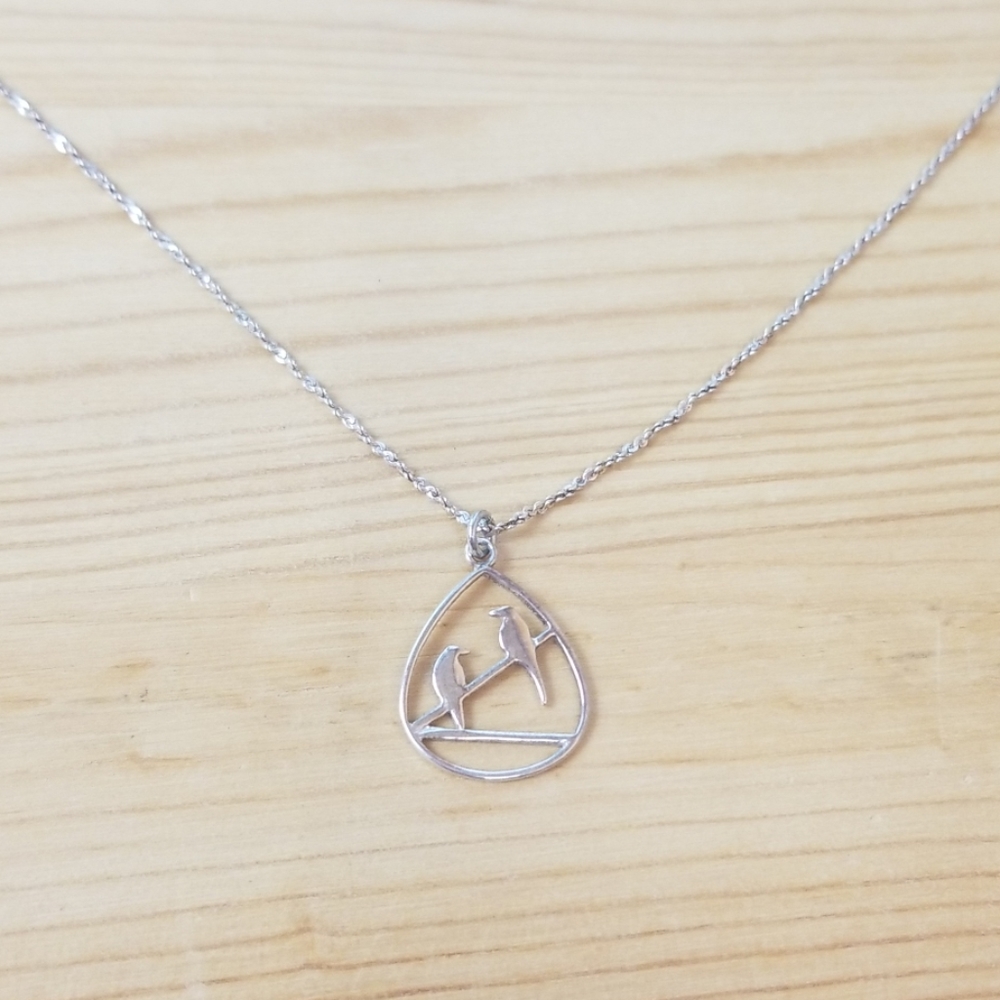 Sterling silver birds on a wire pendant on a chain